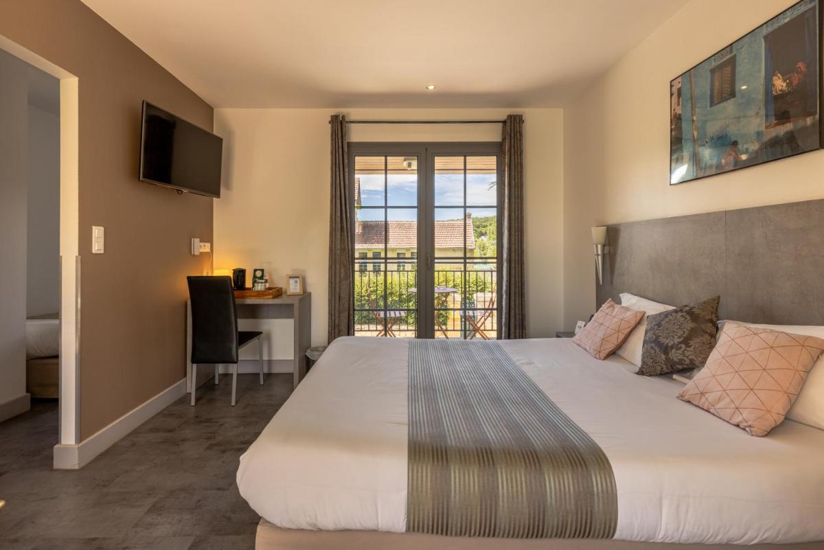 Un ou plusieurs lits dans un hébergement de l'établissement Logis Hotel Archambeau
