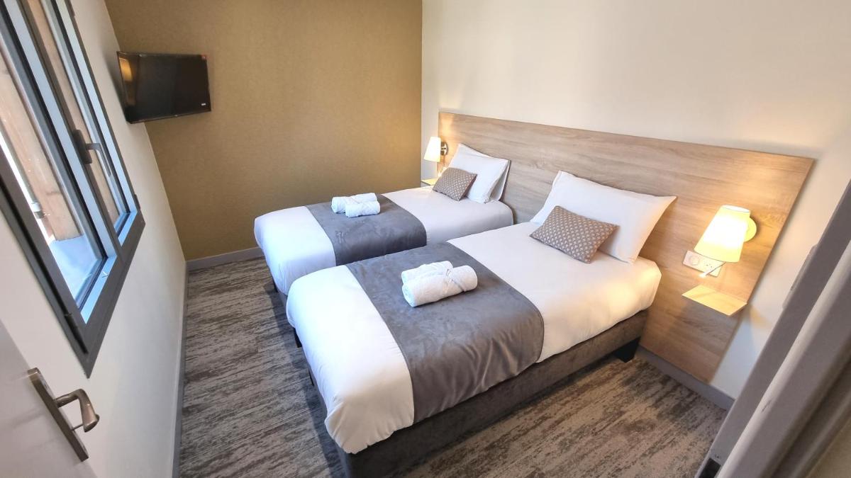 Un ou plusieurs lits dans un hébergement de l'établissement Logis Hotel Archambeau