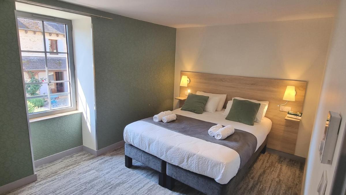 Un ou plusieurs lits dans un hébergement de l'établissement Logis Hotel Archambeau