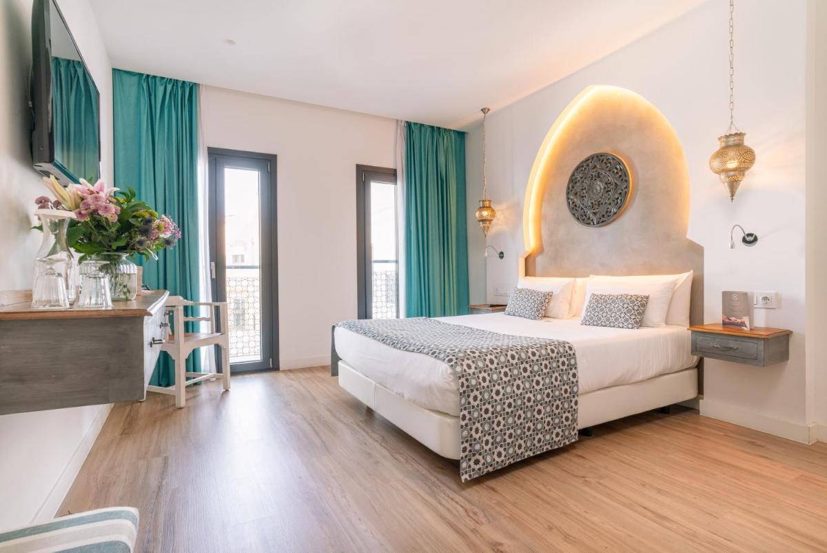 Cama o camas de una habitación en La Residencia Puerto Hotel & Spa