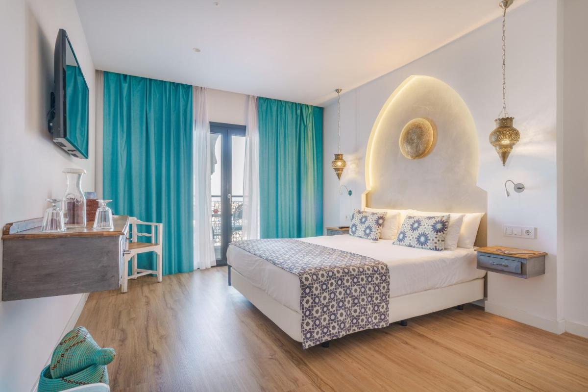 Cama o camas de una habitación en La Residencia Puerto Hotel & Spa
