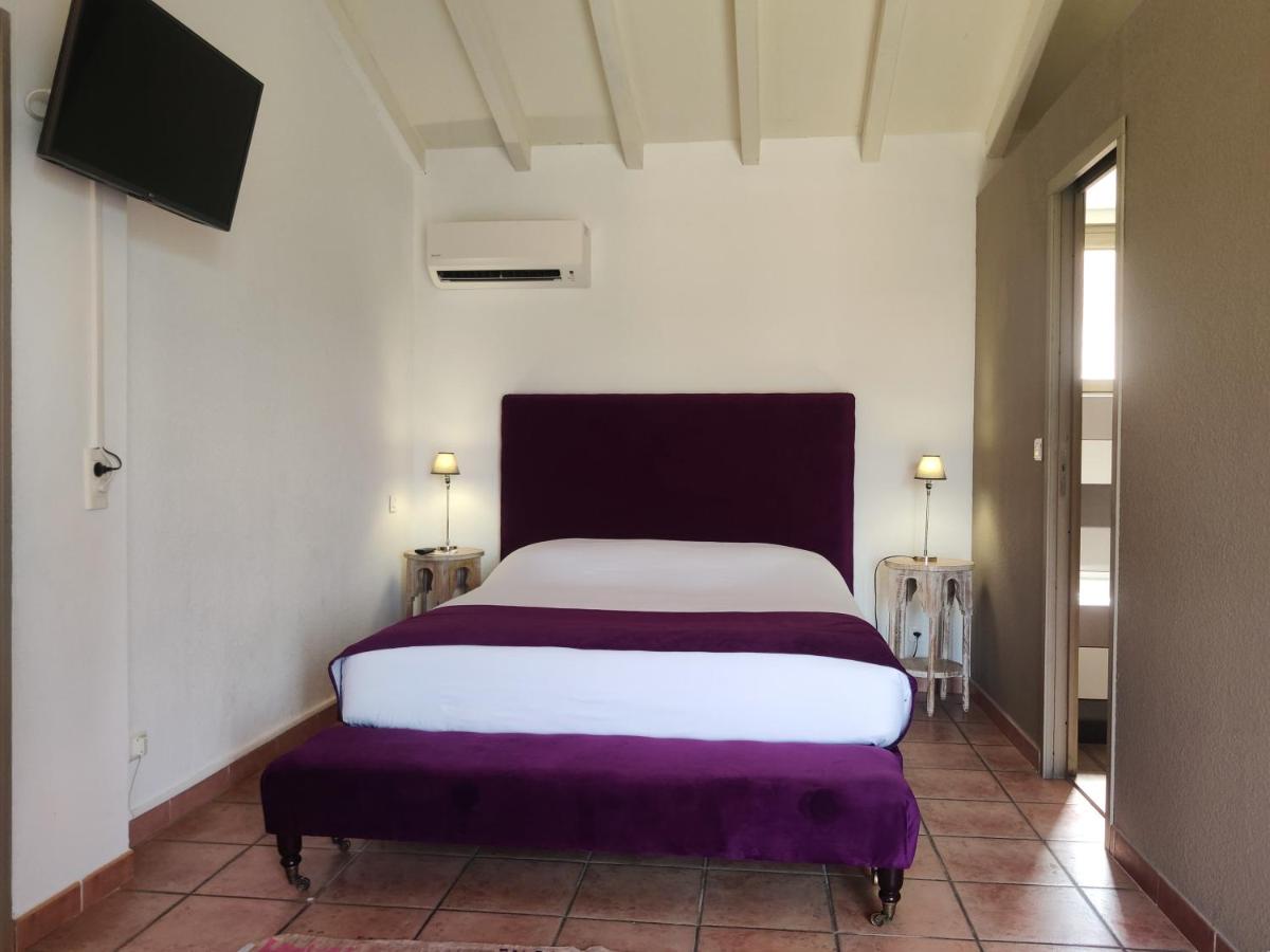 Un ou plusieurs lits dans un hébergement de l'établissement Le Roc E Fiori Hotel - Teritoria