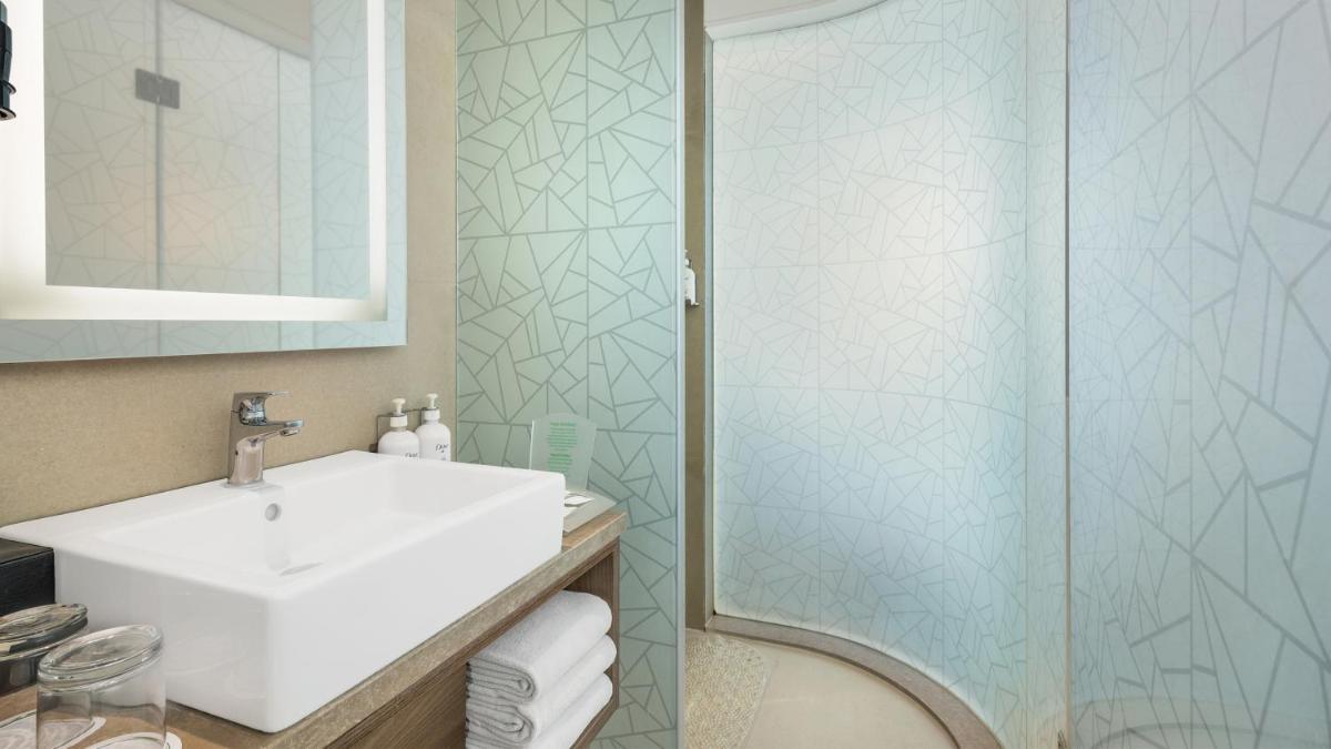 a bathroom with a sink and a shower at Holiday Inn Gurugram Sector 90 by IHG in Gurgaon