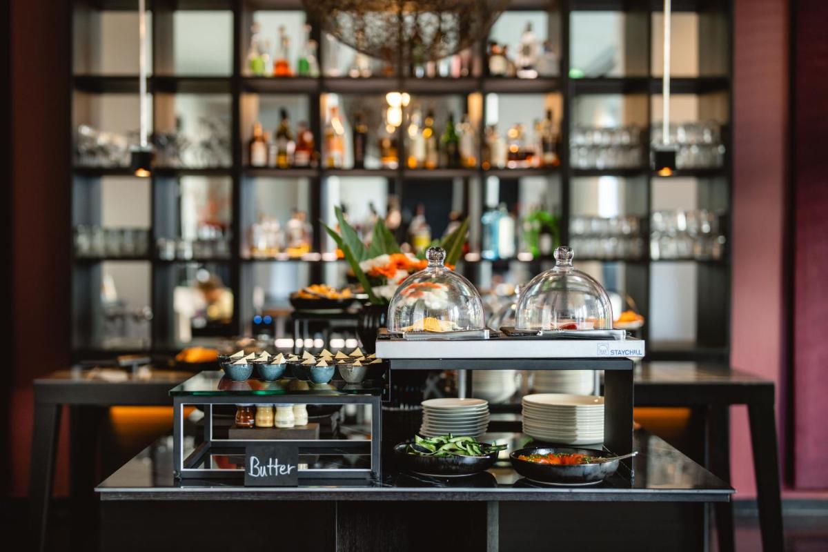 ein Buffet in einem Restaurant mit Tellern und Schüsseln in der Unterkunft A-ROSA Hotel Ceres am Meer - Adults Only in Binz