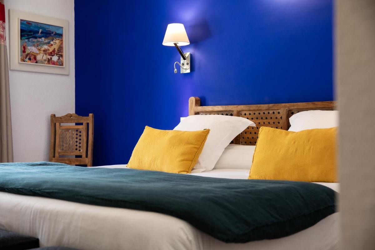 Un ou plusieurs lits dans un hébergement de l'établissement Oustau Camarguen Hôtel & Spa