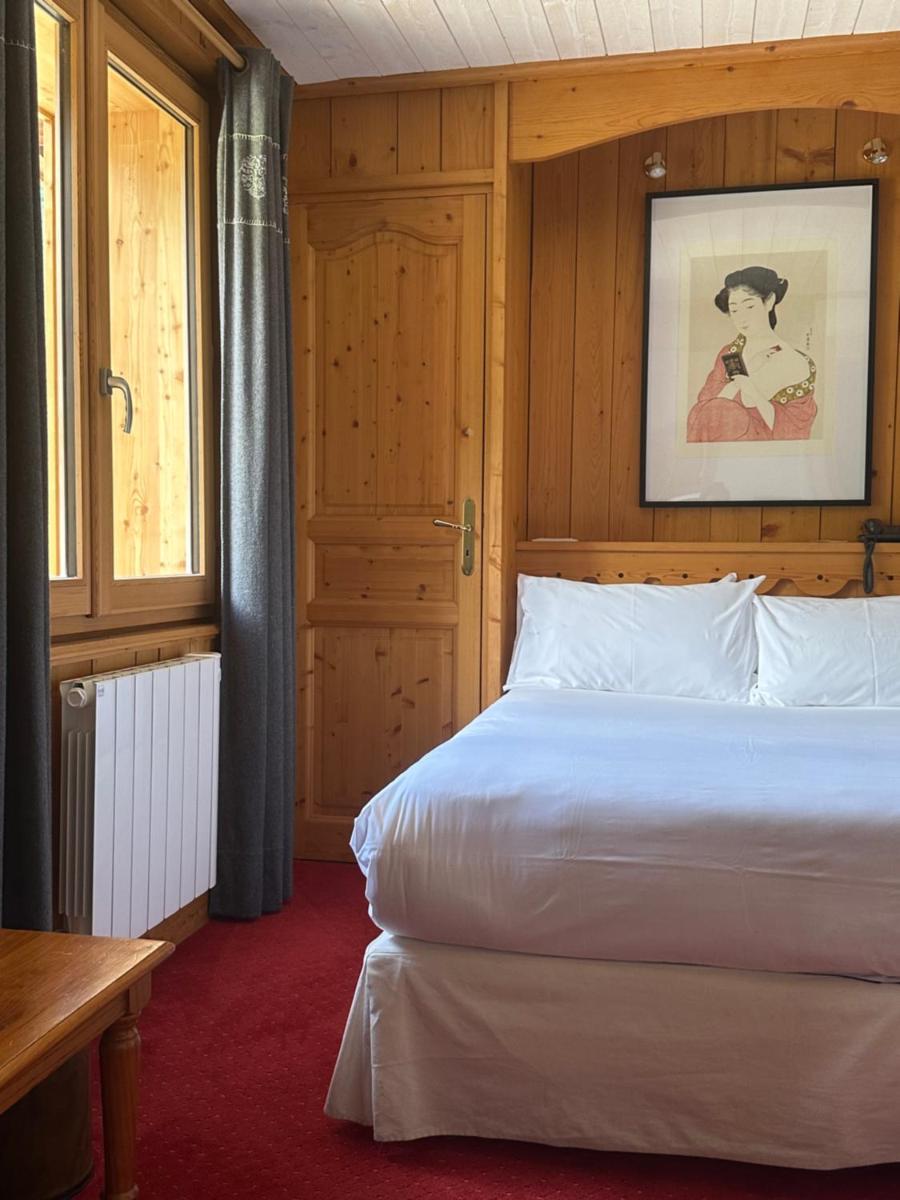 Un ou plusieurs lits dans un hébergement de l'établissement Hôtel Le Jeu de Paume