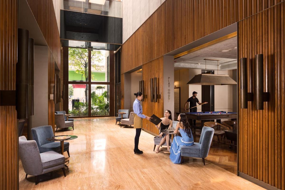 a group of people in a room with a pool table at The Den, Bengaluru in Bengaluru