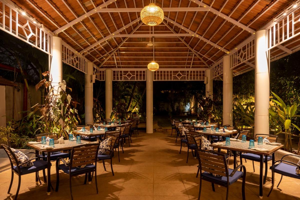 a row of tables and chairs in a restaurant at Southern Star,Mysore in Mysore