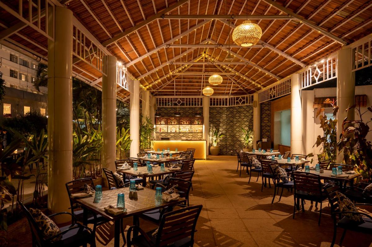 a restaurant with tables and chairs in a building at Southern Star,Mysore in Mysore