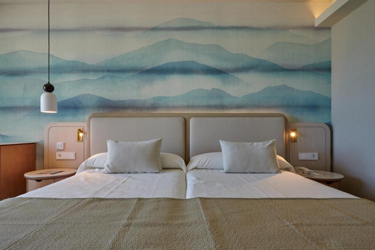 Cama o camas de una habitación en Hipotels Flamenco