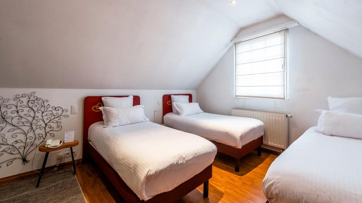 Un ou plusieurs lits dans un hébergement de l'établissement Best Western Plus Au cheval Blanc à Mulhouse