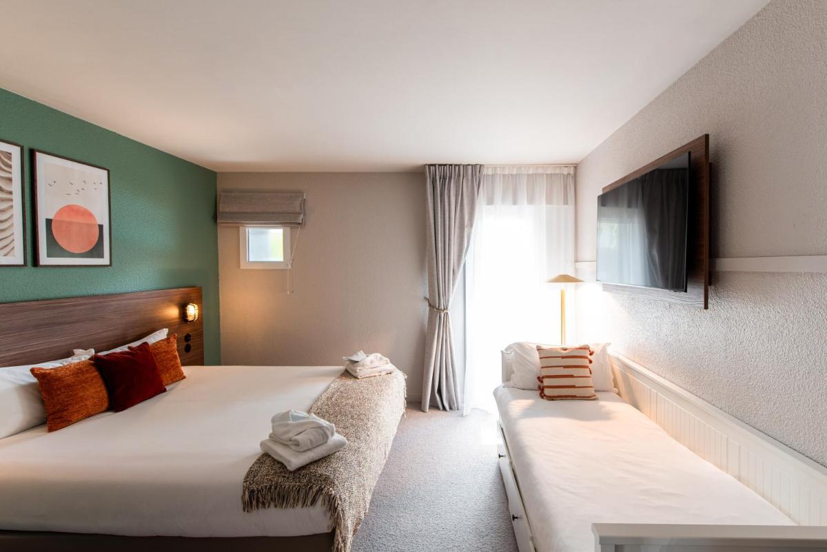 Un ou plusieurs lits dans un hébergement de l'établissement La Maison OBONO Hôtel & Spa