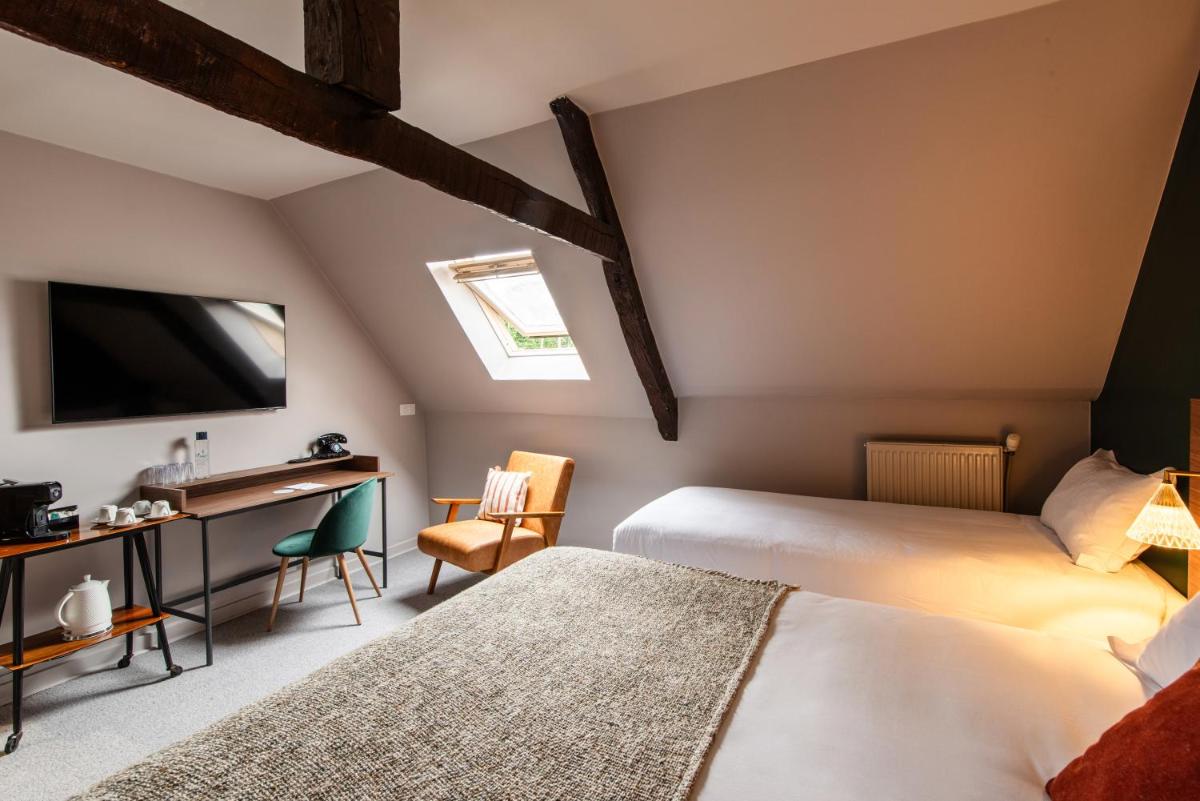 Un ou plusieurs lits dans un hébergement de l'établissement La Maison OBONO Hôtel & Spa