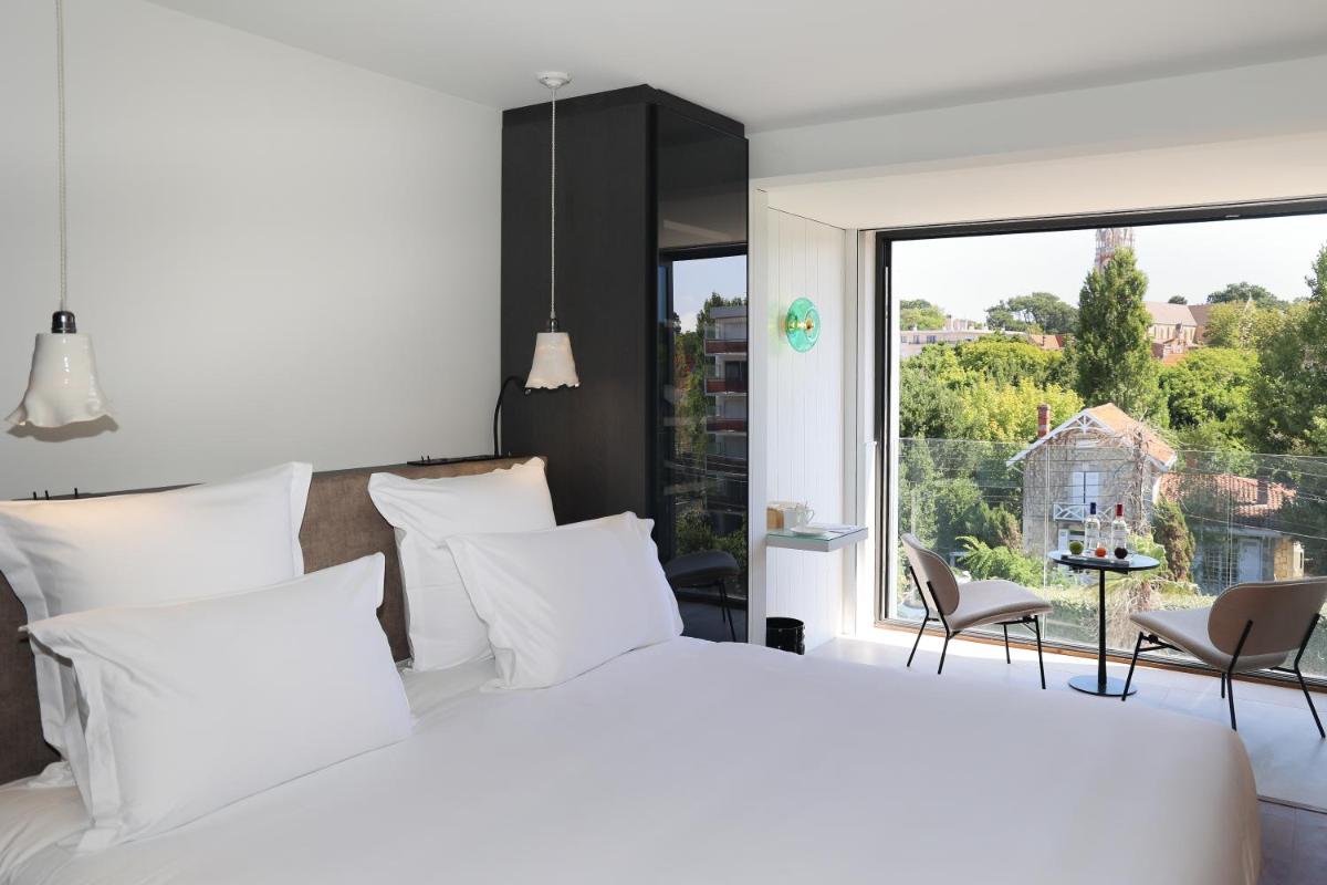 Un ou plusieurs lits dans un hébergement de l'établissement Les Vagues Hotel & Spa