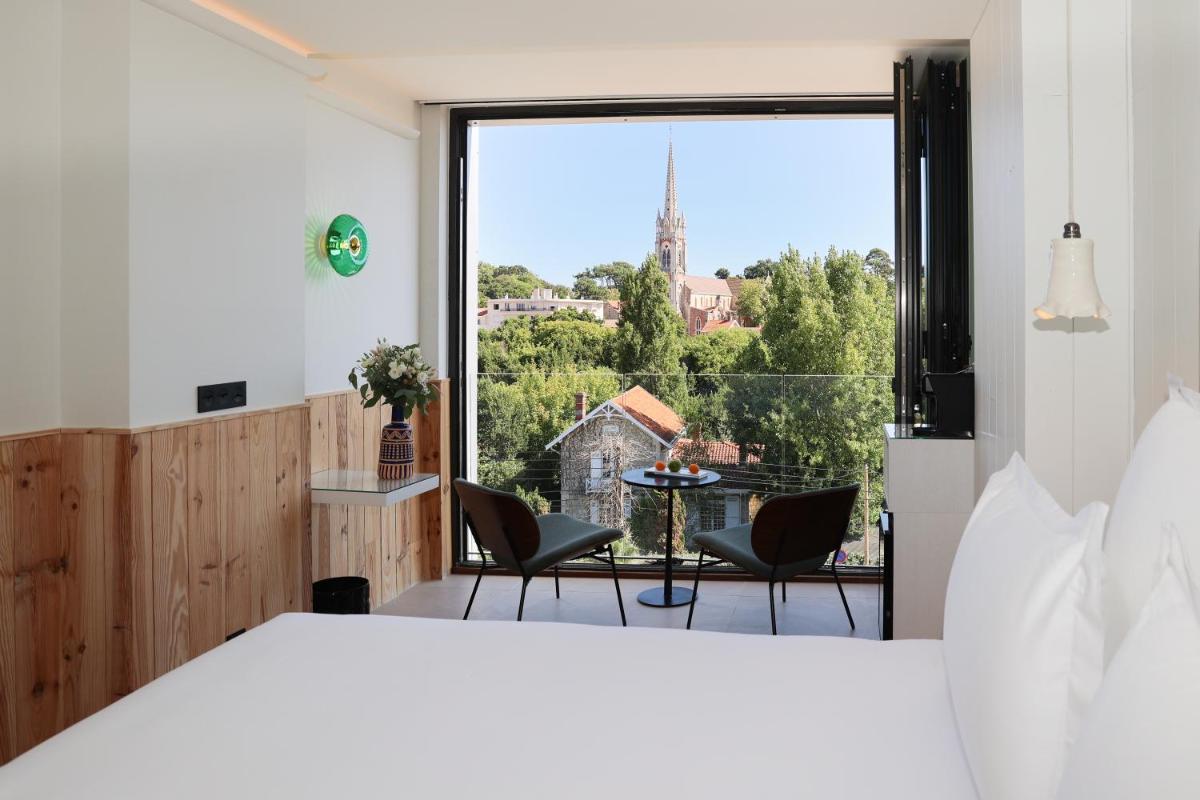 Un ou plusieurs lits dans un hébergement de l'établissement Les Vagues Hotel & Spa