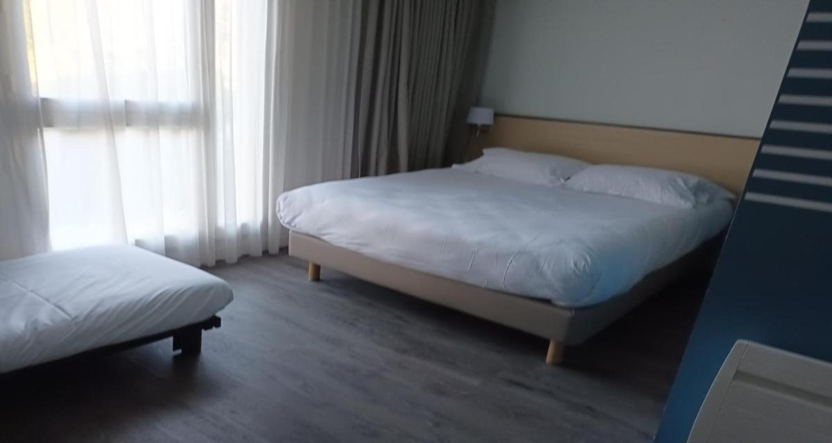 Un ou plusieurs lits dans un hébergement de l'établissement Best Western Armor Park Dinan et Spa