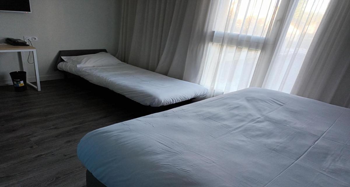 Un ou plusieurs lits dans un hébergement de l'établissement Best Western Armor Park Dinan et Spa
