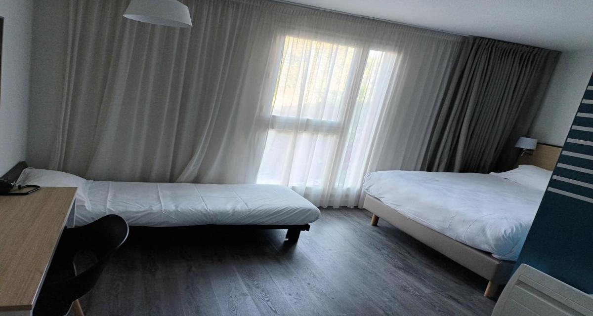 Un ou plusieurs lits dans un hébergement de l'établissement Best Western Armor Park Dinan et Spa