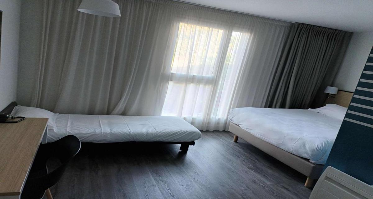 Un ou plusieurs lits dans un hébergement de l'établissement Best Western Armor Park Dinan et Spa