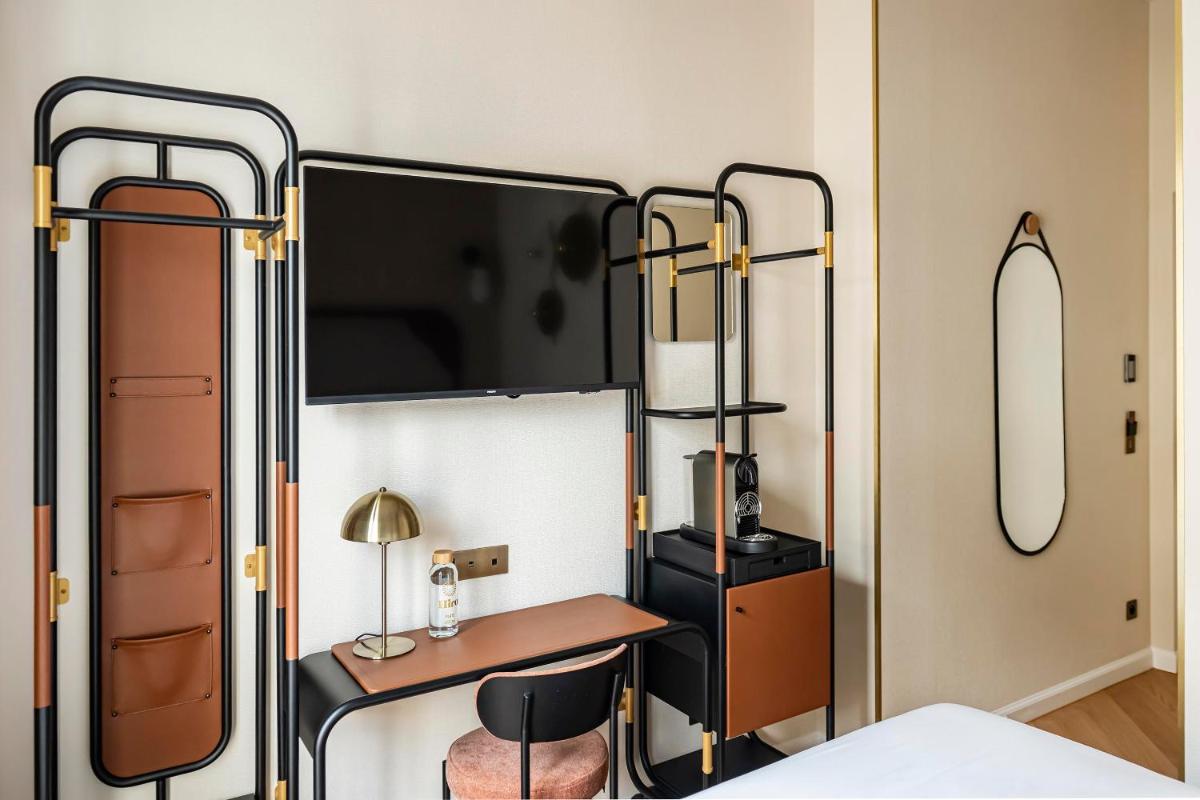 Un ou plusieurs lits dans un hébergement de l'établissement Hôtel Hiro Paris