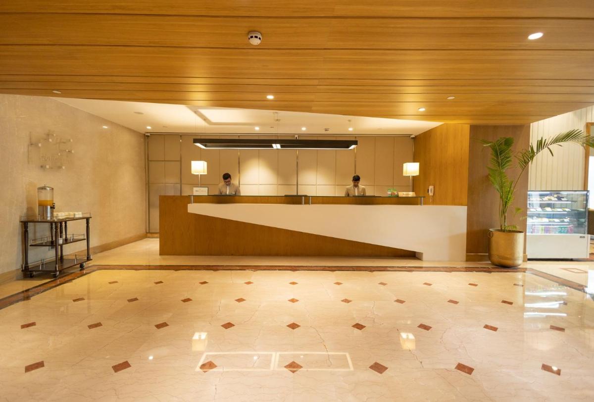 a lobby of a hotel with a reception desk at Holiday Inn Agra MG Road an IHG Hotel in Agra