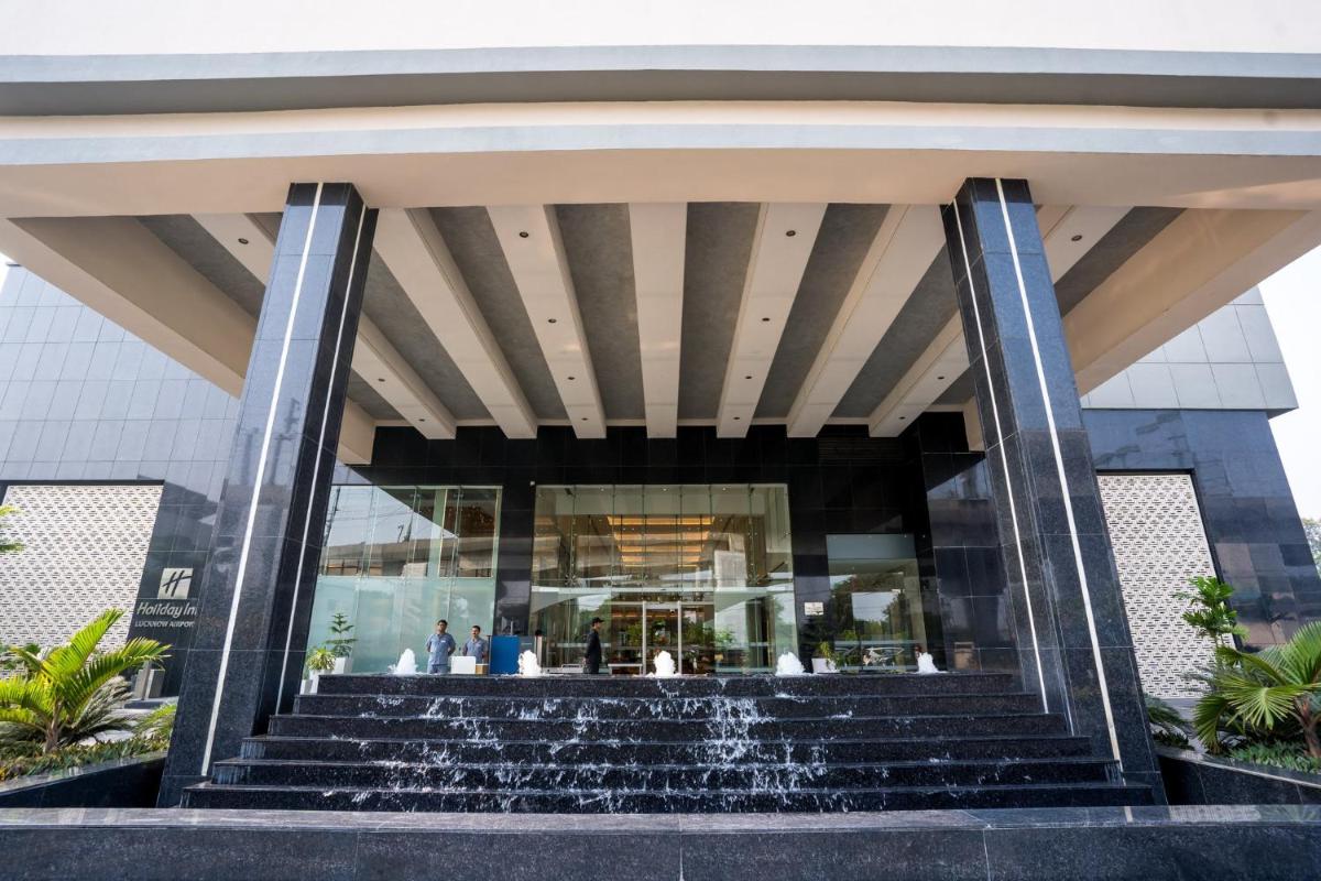 a building with a fountain in front of it at Holiday Inn Lucknow Airport by IHG in Lucknow