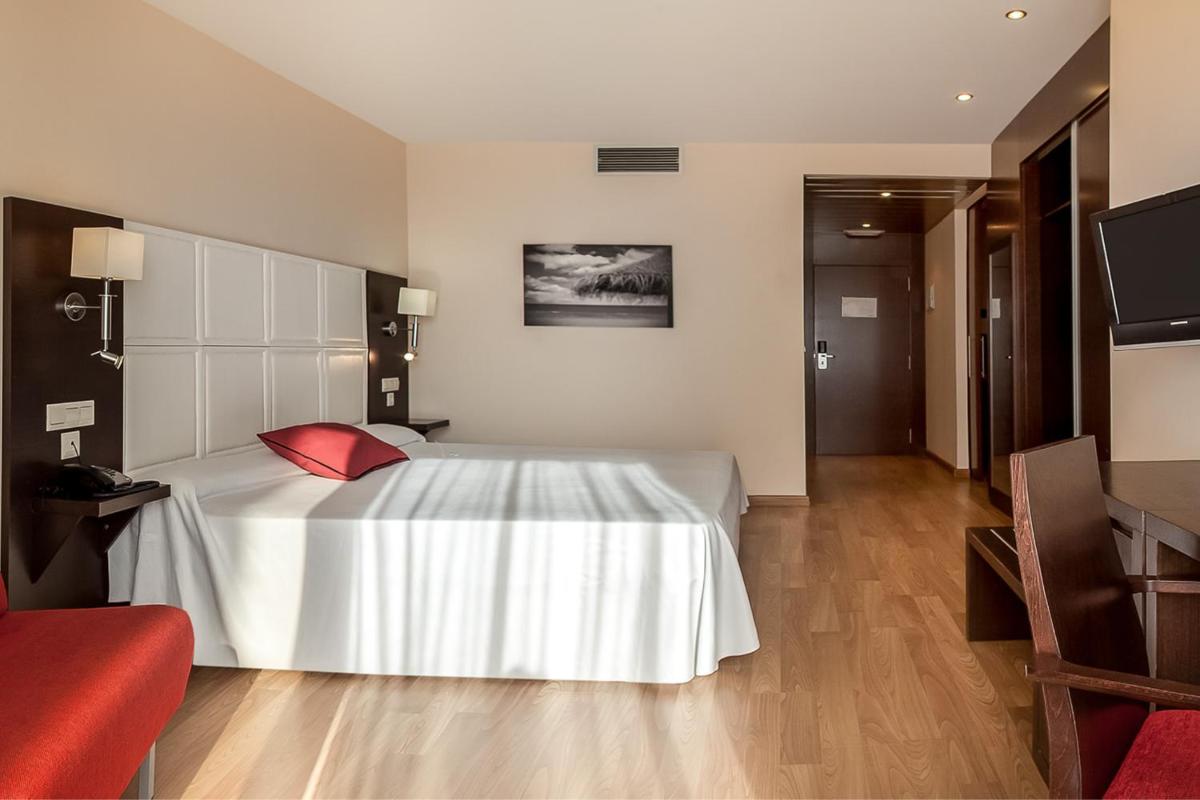 Cama o camas de una habitación en RH Don Carlos & Spa