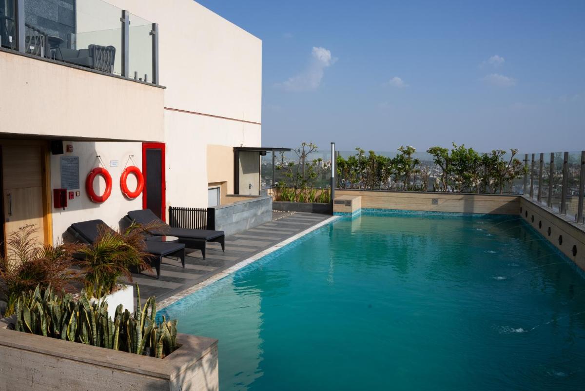 a swimming pool on the side of a building at Hyatt Place Jaipur Malviya Nagar in Jaipur a swimming pool on the side of a building at Hyatt Place Jaipur Malviya Nagar in Jaipur