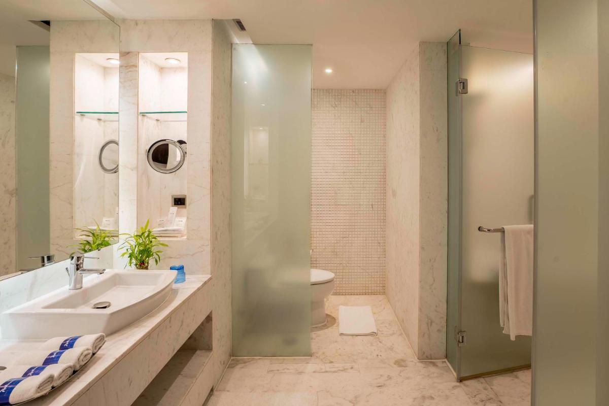 a bathroom with a sink and a toilet and a shower at Radisson Blu Hotel Amritsar in Amritsar