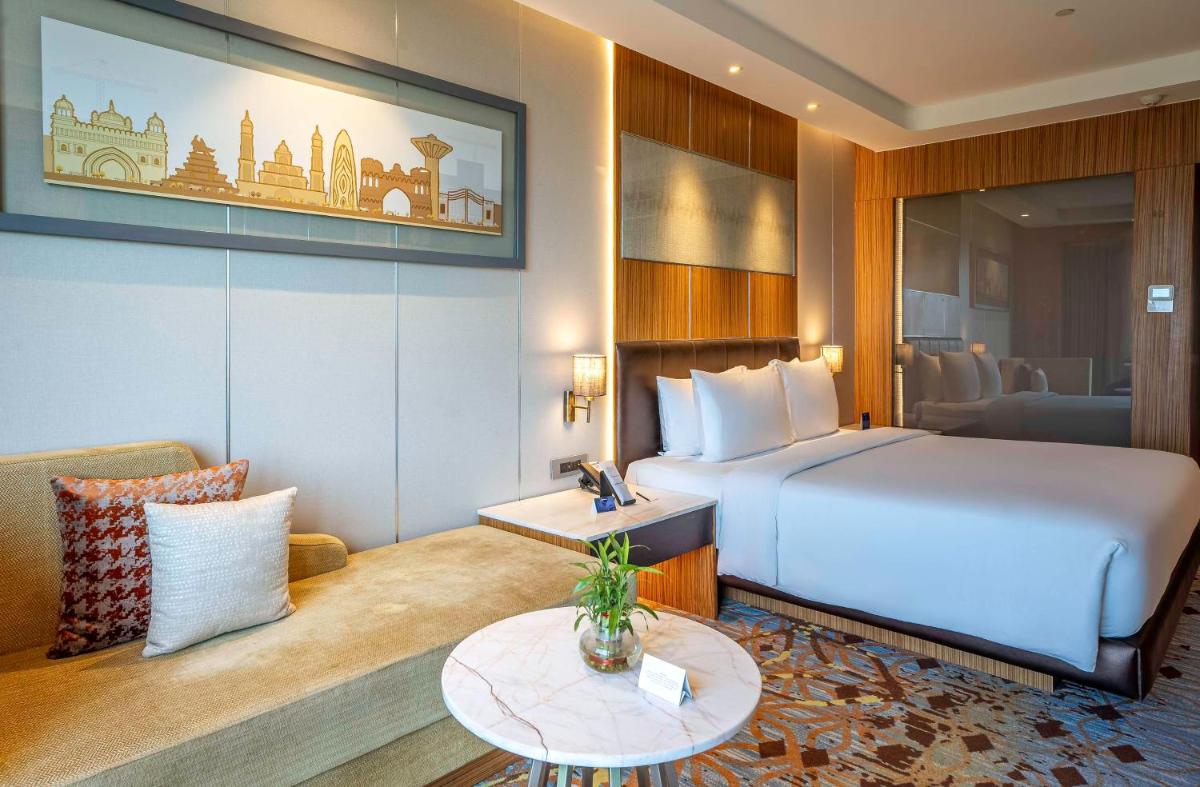 a hotel room with a bed and a table at Radisson Blu Hotel Amritsar in Amritsar