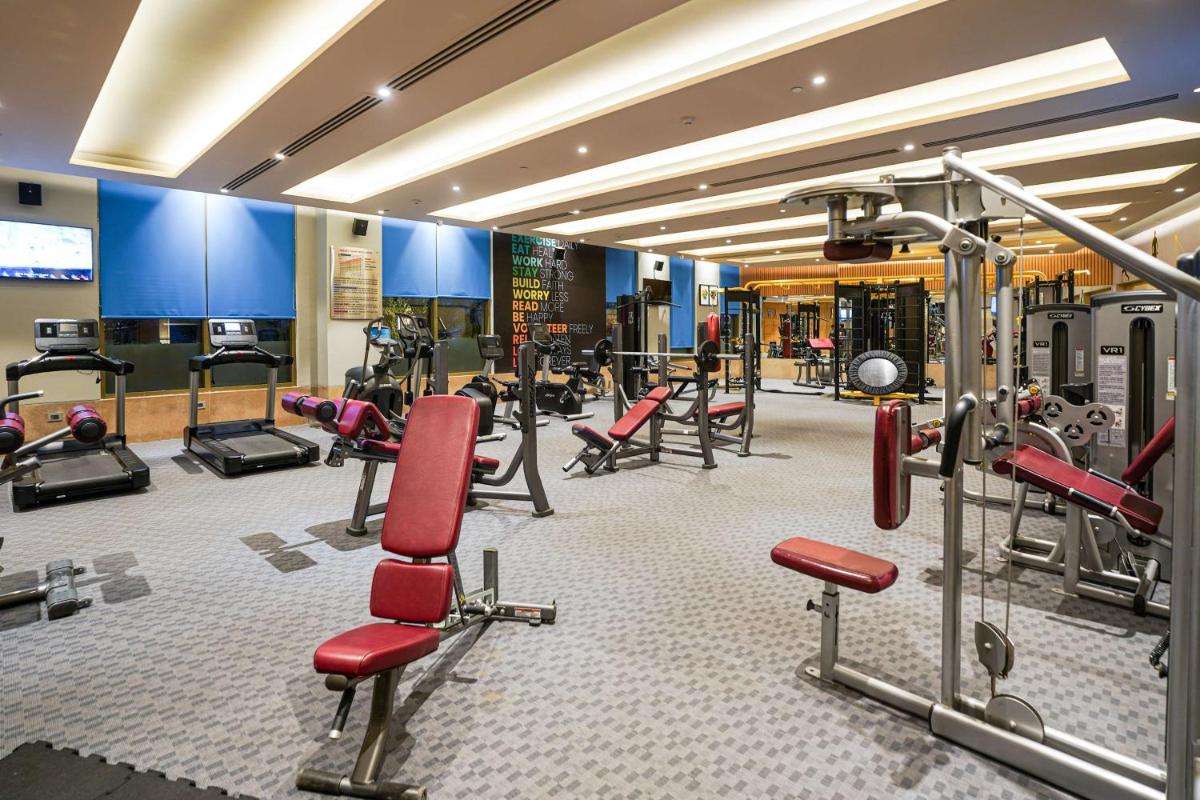 a gym with a lot of treadmills and machines at Radisson Blu Hotel Amritsar in Amritsar