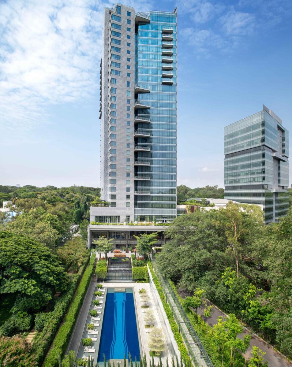 a view of a tall building with a swimming pool at Four Seasons Hotel Bengaluru at Embassy ONE in Bengaluru a view of a tall building with a swimming pool at Four Seasons Hotel Bengaluru at Embassy ONE in Bengaluru