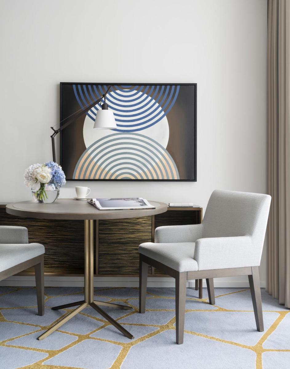 a living room with a table and two chairs at Four Seasons Hotel Bengaluru at Embassy ONE in Bengaluru a living room with a table and two chairs at Four Seasons Hotel Bengaluru at Embassy ONE in Bengaluru