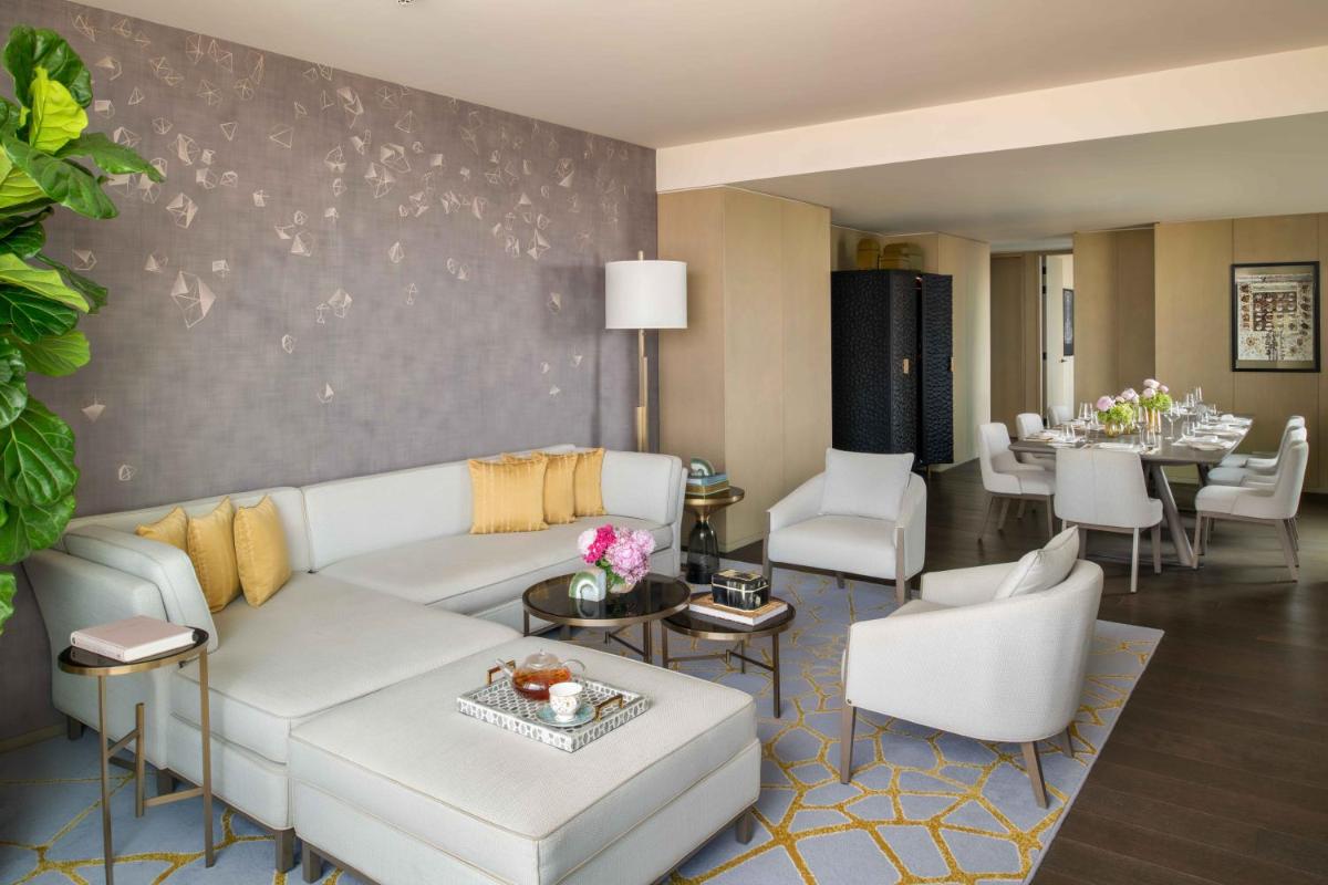 a living room with a white couch and a table at Four Seasons Hotel Bengaluru at Embassy ONE in Bengaluru a living room with a white couch and a table at Four Seasons Hotel Bengaluru at Embassy ONE in Bengaluru