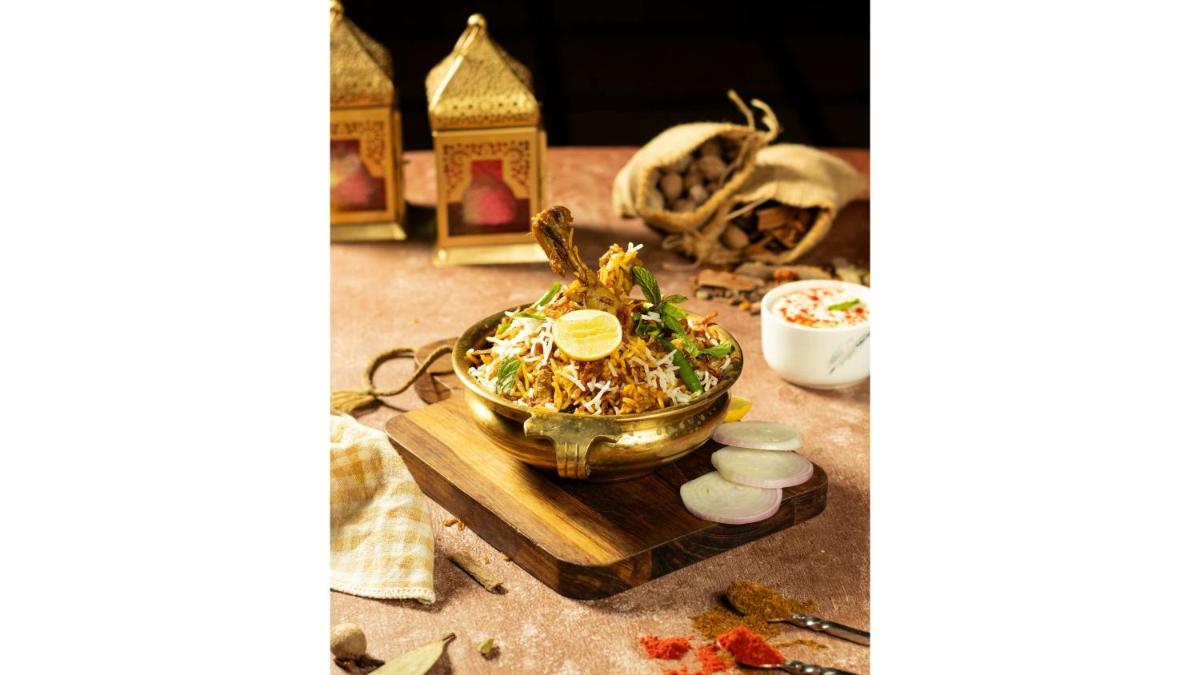 a table with a bowl of food on a cutting board at Radisson Blu Hotel Ahmedabad in Ahmedabad