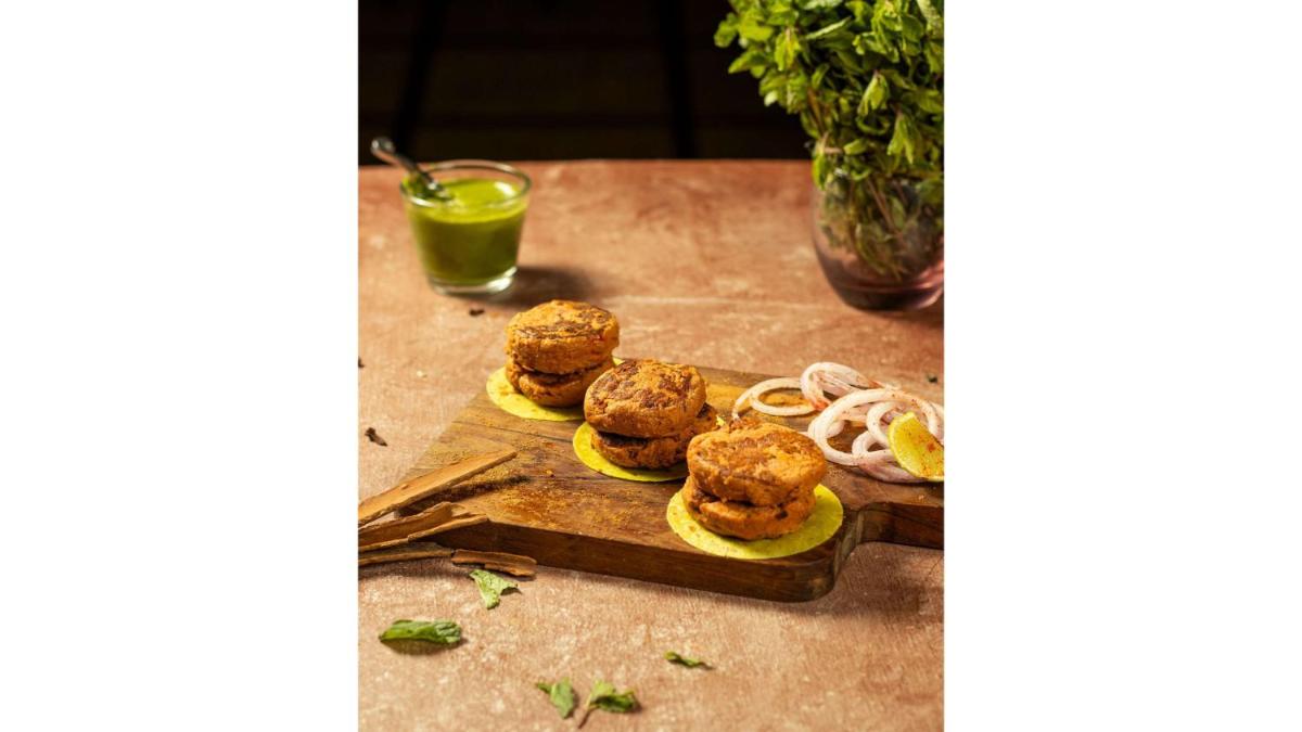 a cutting board with three balls of food on it at Radisson Blu Hotel Ahmedabad in Ahmedabad