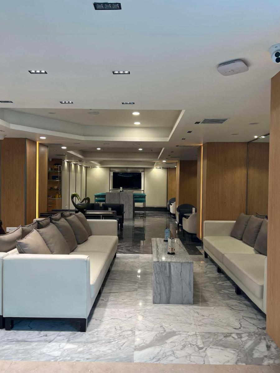 a living room with two white couches and a table at Radisson Blu Hotel Ahmedabad in Ahmedabad