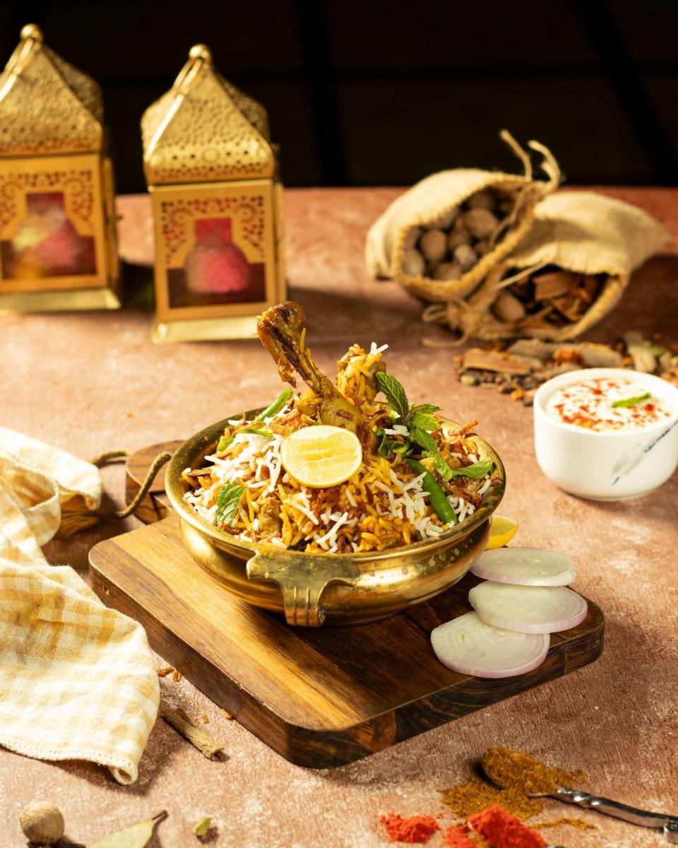 a bowl of food on a wooden cutting board at Radisson Blu Hotel Ahmedabad in Ahmedabad