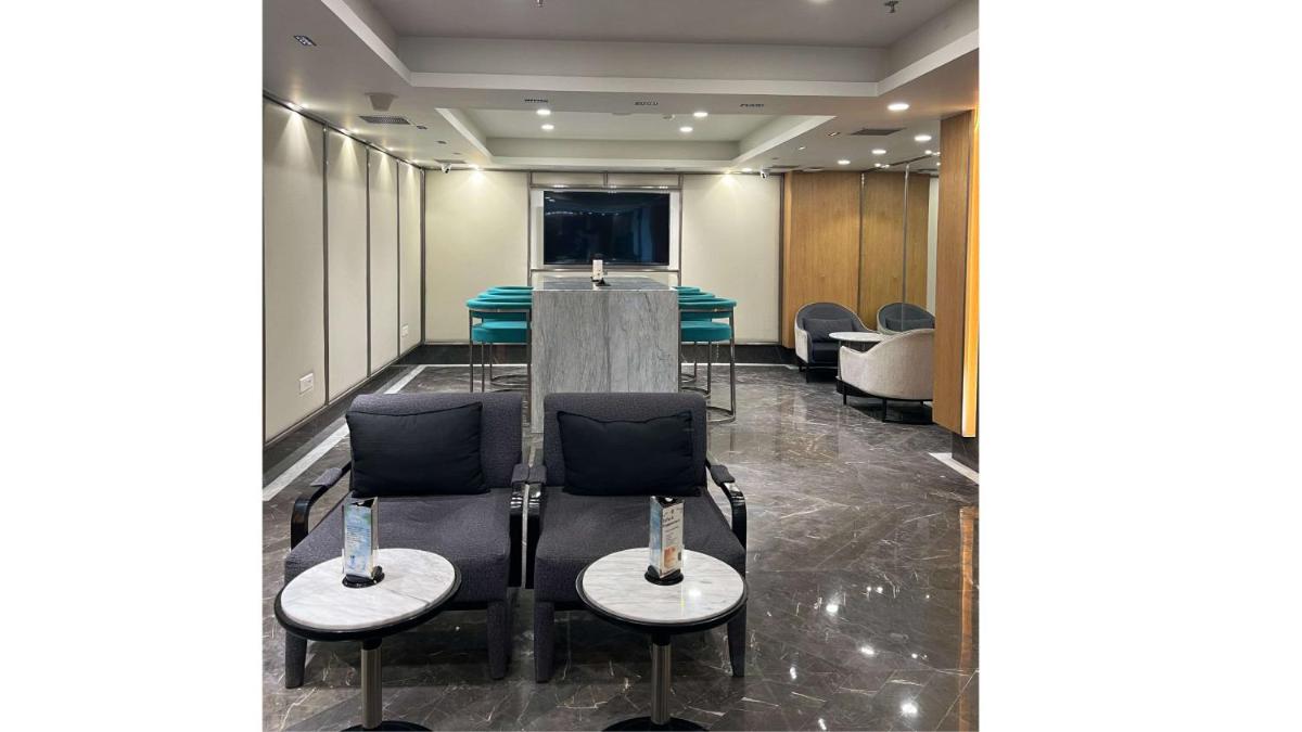 a conference room with a table and chairs at Radisson Blu Hotel Ahmedabad in Ahmedabad