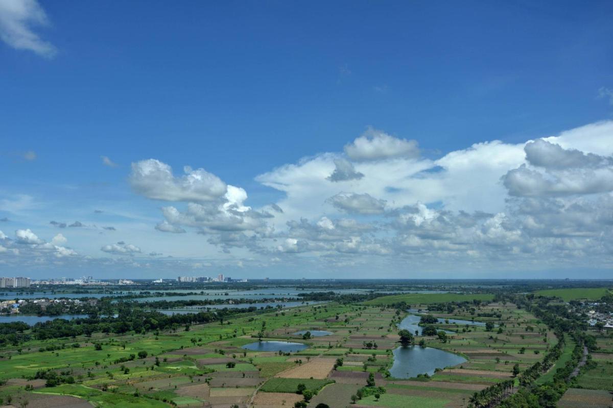 an aerial view of a park with a river and trees at JW Marriott Hotel Kolkata in Kolkata