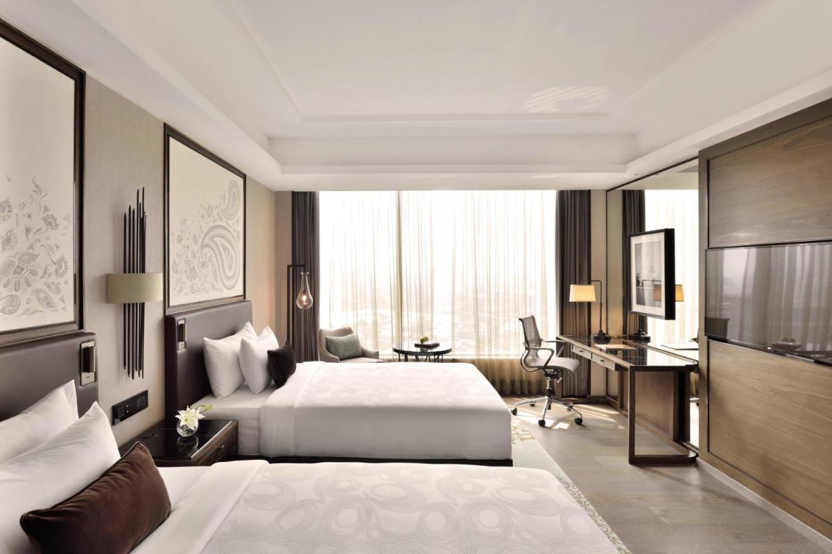 a hotel room with a bed and a desk at JW Marriott Hotel Kolkata in Kolkata