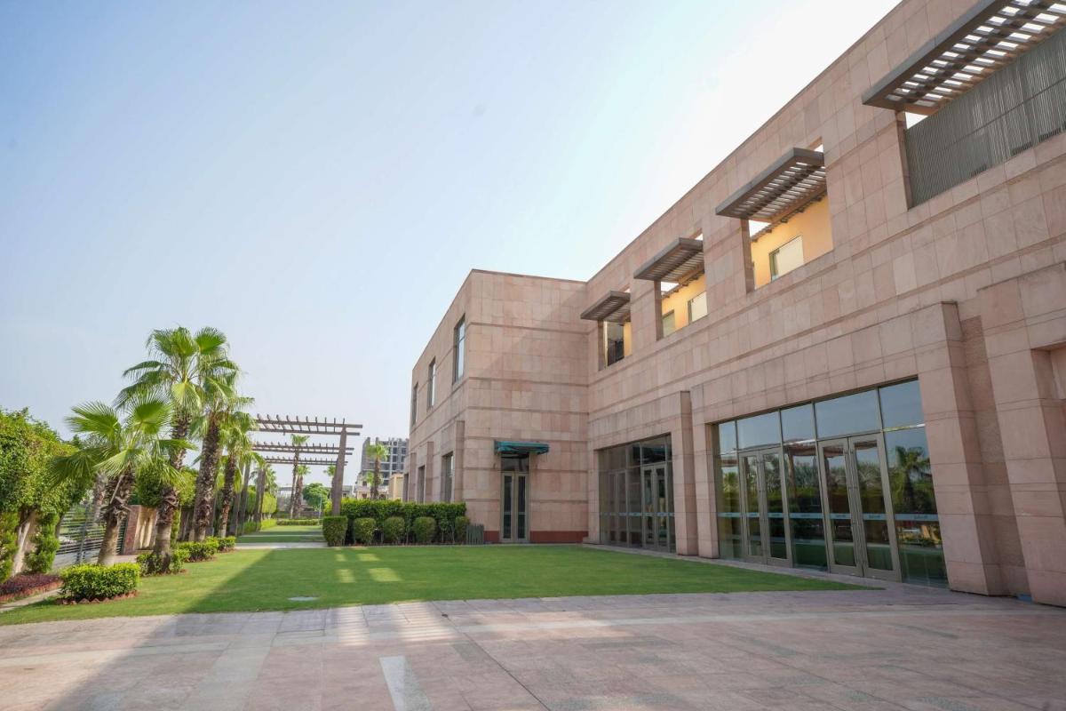 a large building with a lawn in front of it at Radisson Blu Hotel Amritsar in Amritsar