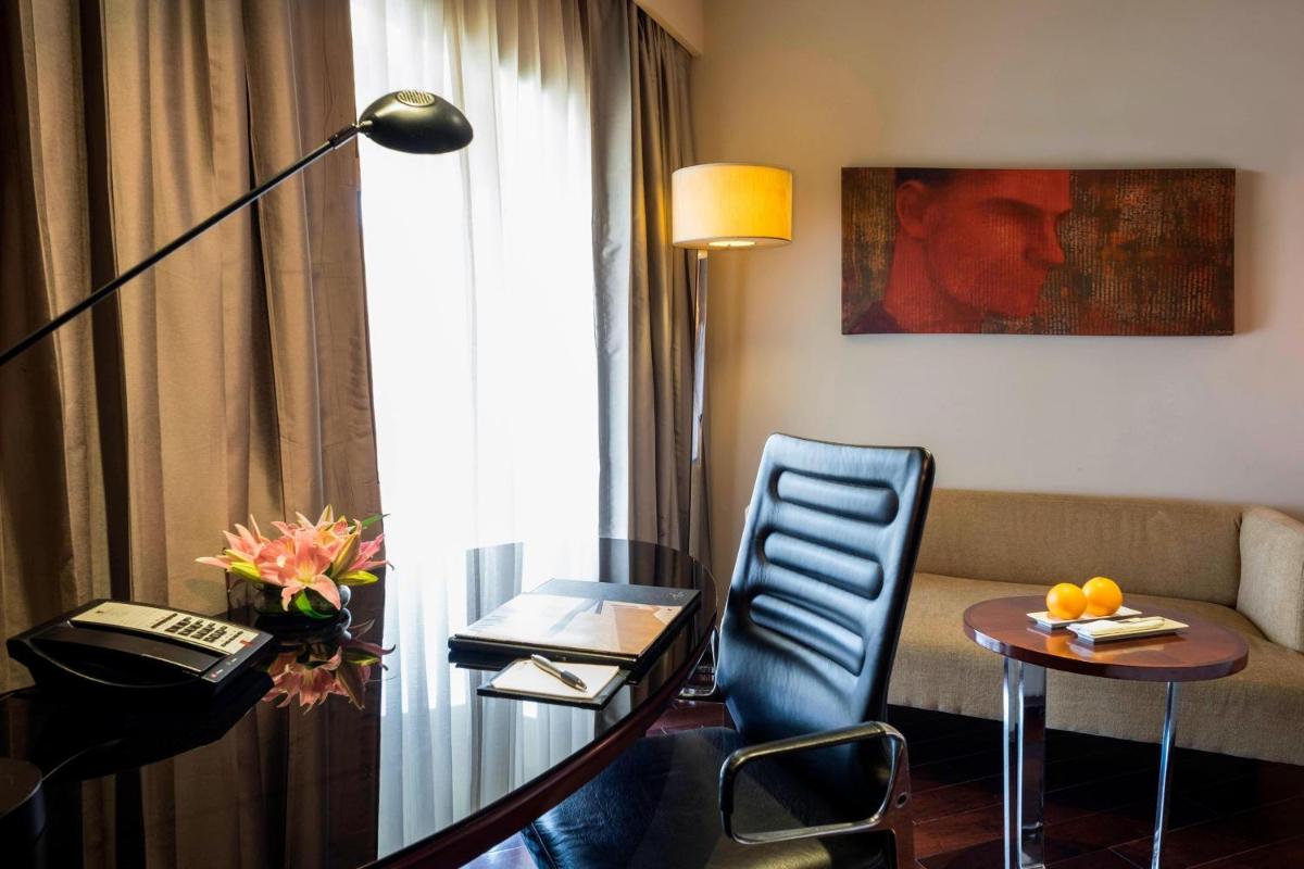 a hotel room with a table and a couch at JW Marriott Mumbai Juhu in Mumbai