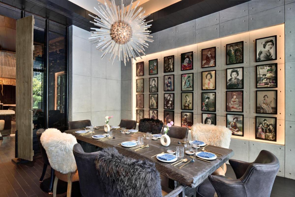 a dining room with a long table and a chandelier at JW Marriott Hotel New Delhi Aerocity in New Delhi a dining room with a long table and a chandelier at JW Marriott Hotel New Delhi Aerocity in New Delhi