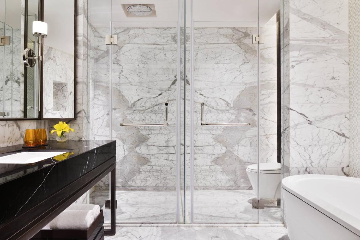 a bathroom with a shower with a glass door at JW Marriott Hotel Kolkata in Kolkata