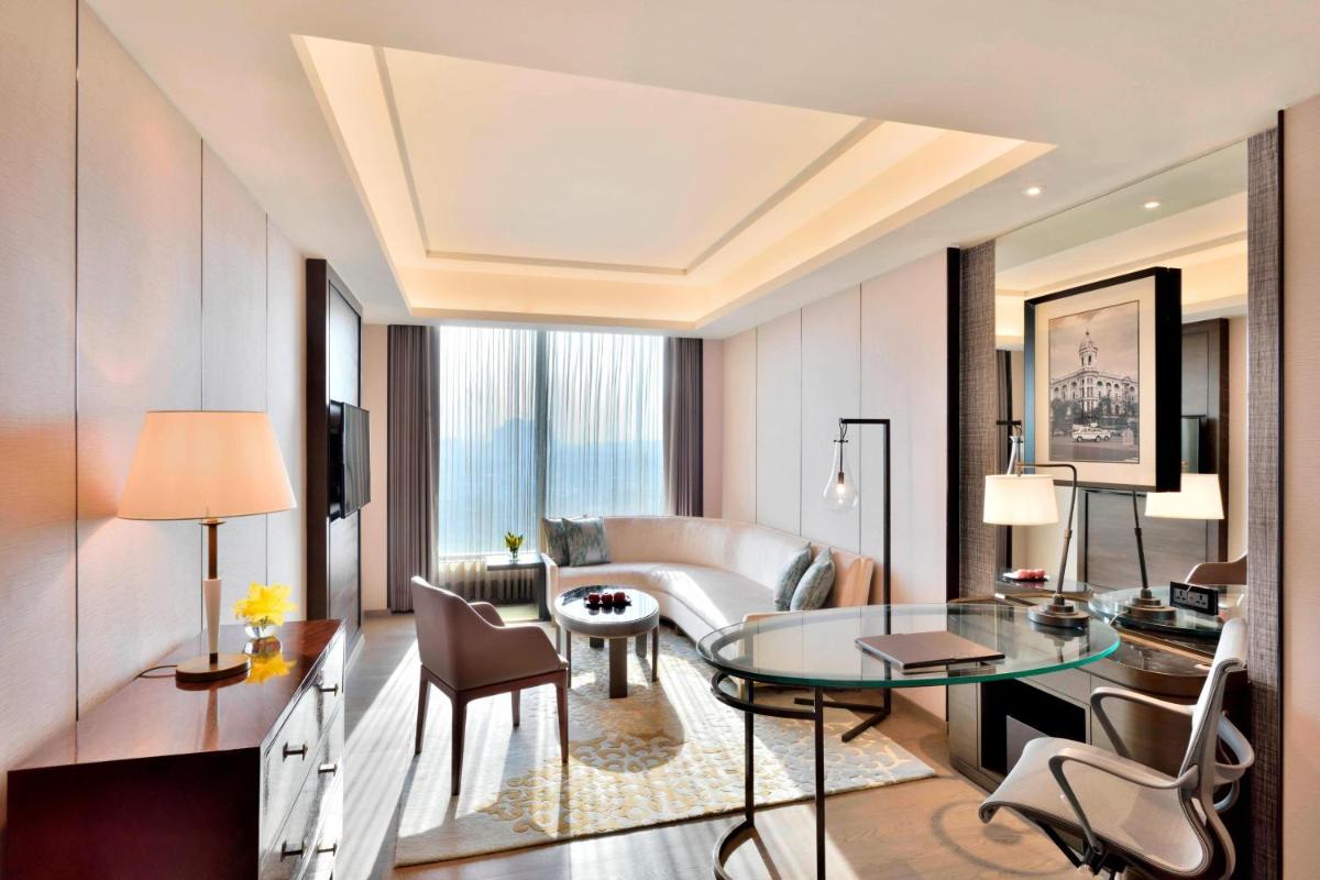a living room with a table and a couch at JW Marriott Hotel Kolkata in Kolkata
