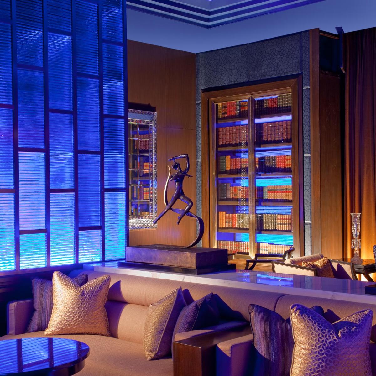 a room with a couch and a statue of a woman on a stage at The Leela Palace Chennai in Chennai a room with a couch and a statue of a woman on a stage at The Leela Palace Chennai in Chennai