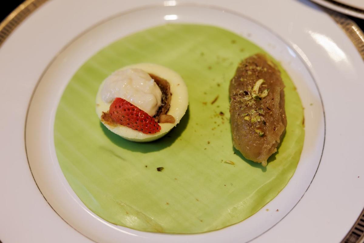 a plate with a dessert on a green plate at The Leela Palace Chennai in Chennai a plate with a dessert on a green plate at The Leela Palace Chennai in Chennai