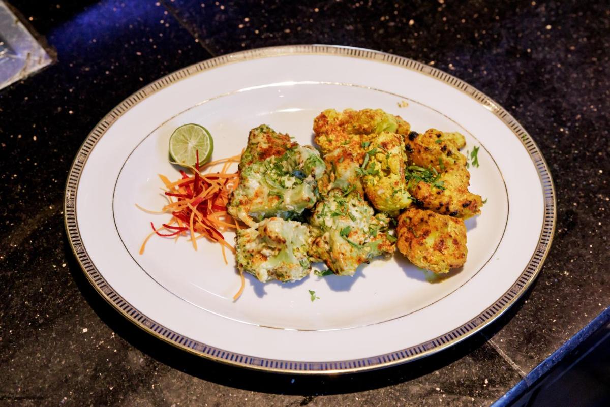 a plate of food on a table with food at The Leela Palace Chennai in Chennai a plate of food on a table with food at The Leela Palace Chennai in Chennai