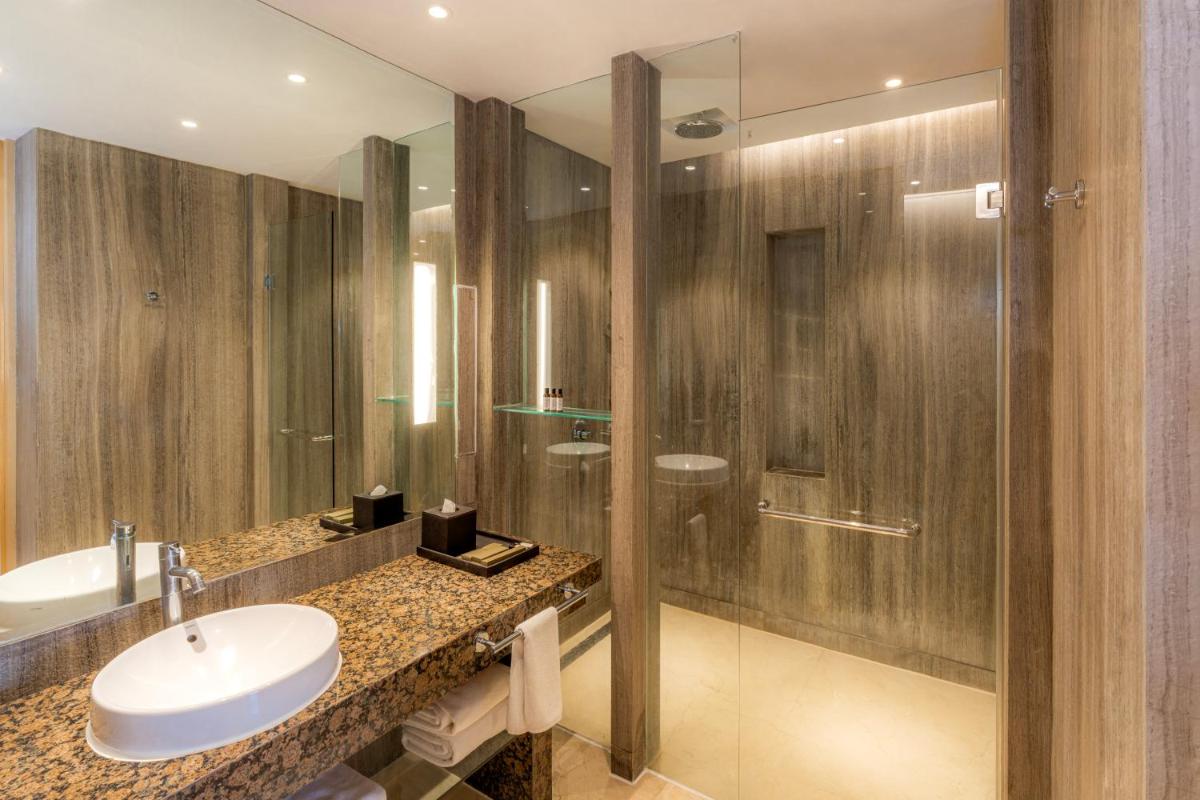 a bathroom with a sink and a shower at Hyatt Regency Pune Hotel & Residences in Pune